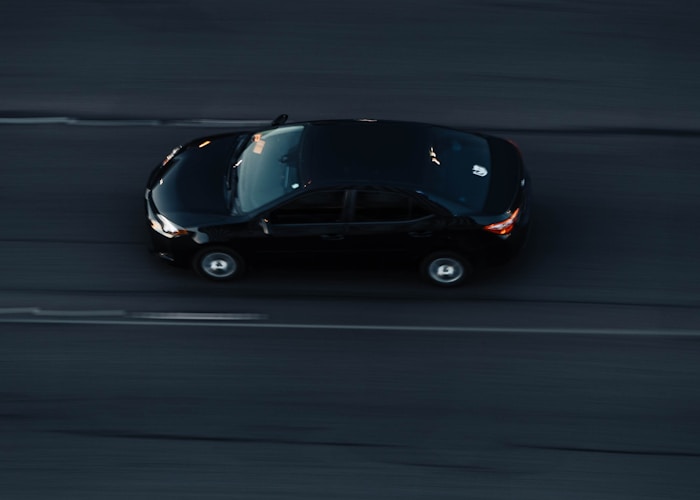Black car on highway at dusk